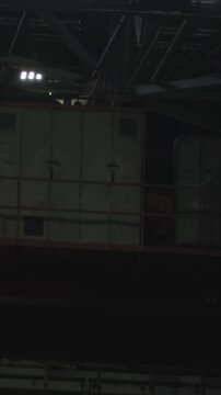 Cinematic Industrial Environment Featuring Technicians Under Lights Inspecting Schematics Amidst Shadows . Stock clip