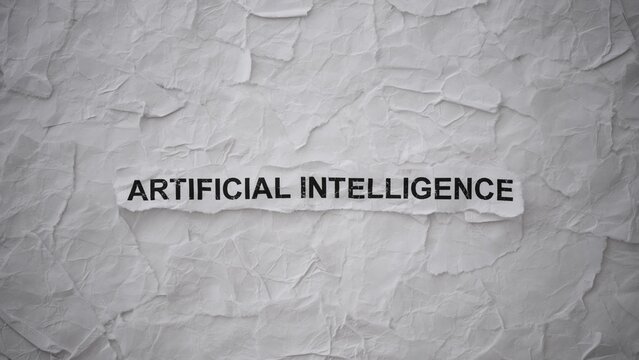 Crumpled piece of paper with words Artificial Intelligence on torn crumpled white paper pieces background.
