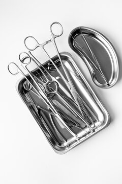 Sterile surgical instruments and tools - scalpels, scissors and others - in a stainless tray, top view