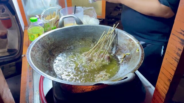 Street Food Vendor Cooking Rolled Eggs in a Hot Pan