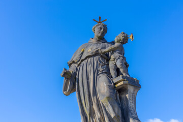 Fototapeta premium Low-angle view of the historic Statue of Saint Anthony of Padua holding the Christ Child on Charles Bridge, Prague.