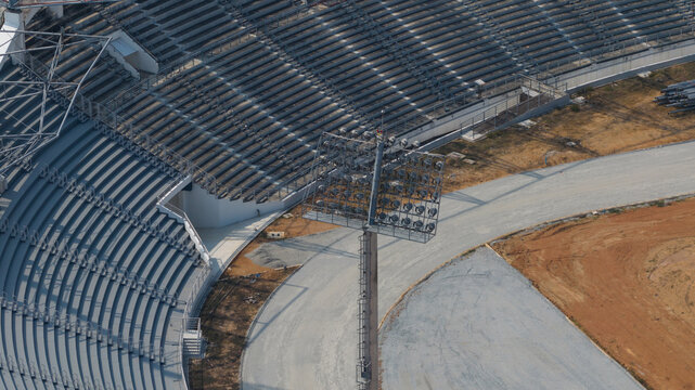 Aerial view of Chaiyaphruek Pattaya Stadium with empty concrete grandstands and a tall floodlight tower in Muang Pattaya, Chang Wat Chon Buri, Thailand.