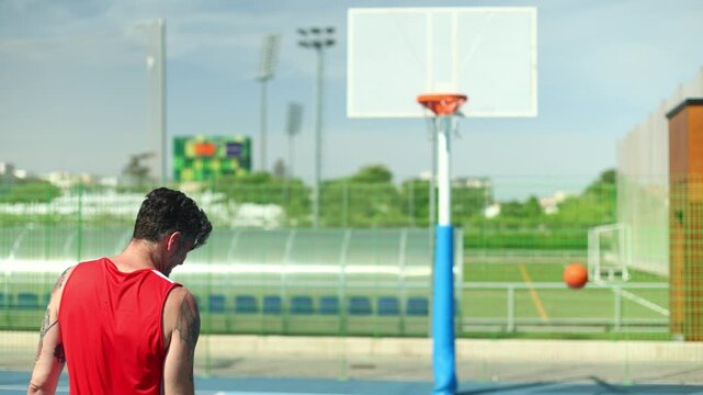 Tattooed basketball player scoring a three point shot