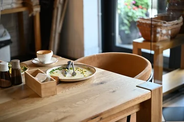 Fotobehang Horeca Empty Plate After Breakfast on Rustic Wooden Restaurant Table  © Miroslaw