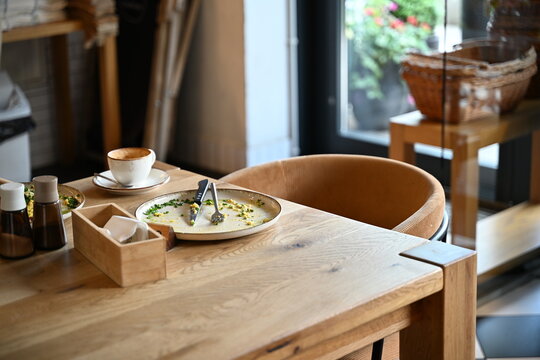 Empty Plate After Breakfast on Rustic Wooden Restaurant Table