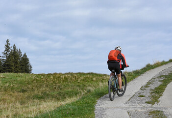 Fototapeta premium Cyclist on a mountain road in the Swiss Alps