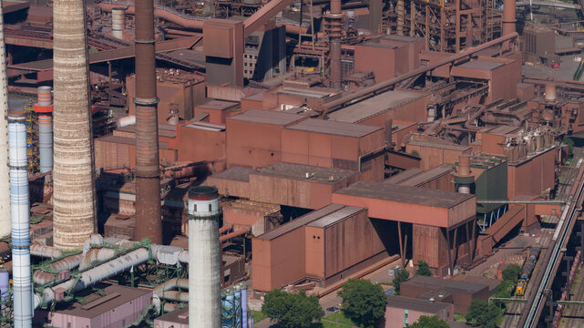 Aerial view of the Kokerei Schwelgern KBS thyssenkrupp Steel plant with its massive industrial structures and tall chimneys in Duisburg, North Rhine-Westphalia, Germany.