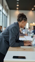 Obraz premium Happy African American Businesswoman Working at Laptop