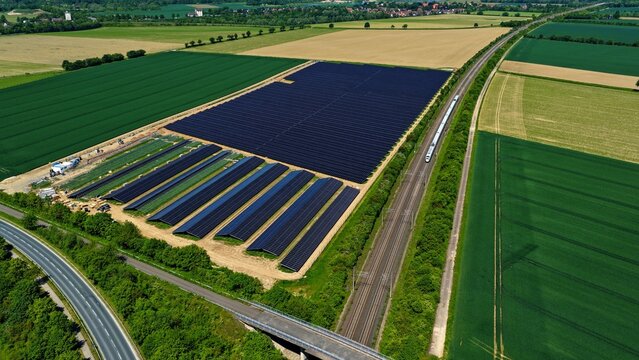 Large Solar Farm Aerial View Next to Green Fields and Railway Germany