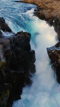Epic Waterfall in scenic iceland nature, aerial shot - vertical video