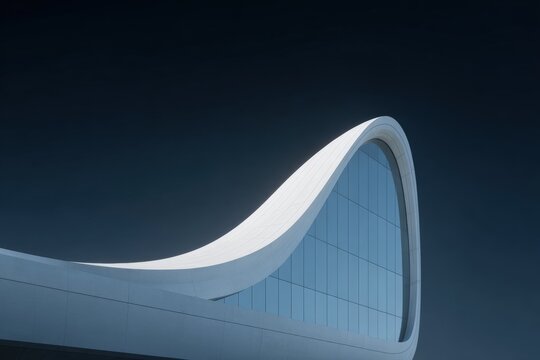 A white building with a curved roof against a dark blue sky.