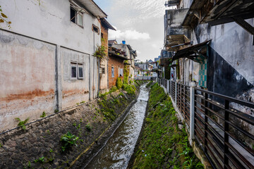 Fototapeta premium Narrow canal between residential buildings in Kota Malang
