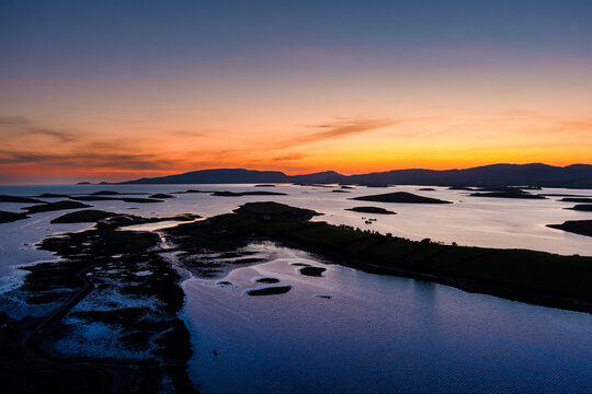 Aerial sunset view over Clew Bay near Westport, County Mayo, Ireland. Scenic Atlantic bay with drumlin islands and mountain silhouettes on the Wild Atlantic Way.