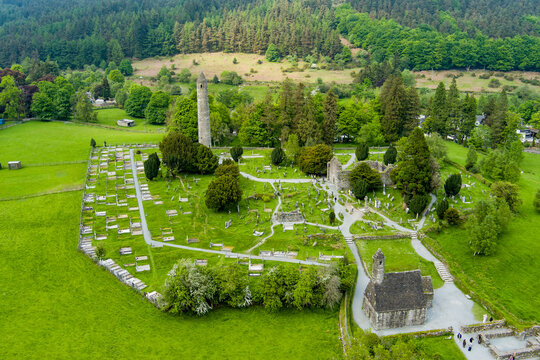Aerial view of ancient cemetery and round tower at Glendalough Monastic Site in County Wicklow, Ireland. Historic Irish landmark in Wicklow Mountains National Park