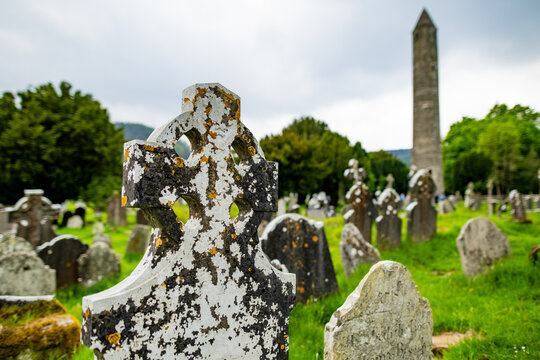 Ancient cemetery and round tower at Glendalough Monastic Site in County Wicklow, Ireland. Historic Irish landmark in Wicklow Mountains National Park.