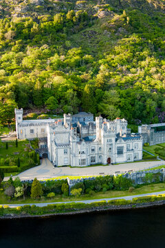 Aerial view of Kylemore Abbey on Pollacappul Lough in Connemara, County Galway, Ireland. Historic neo Gothic abbey and lakeside estate in a wooded mountain landscape.