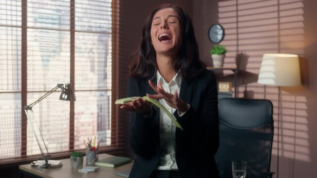 Happy Caucasian business woman holding money in office businesswoman excited to throw cash female manager celebrating financial success salary bonus profit professional employee indoors workplace