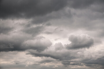 Obraz premium Dramatic storm clouds for the background. Isolated summer storm clouds before a thunderstorm. Dark storm clouds before the rain. Bad weather. A heavenly landscape of clouds in the sky on a rainy day.