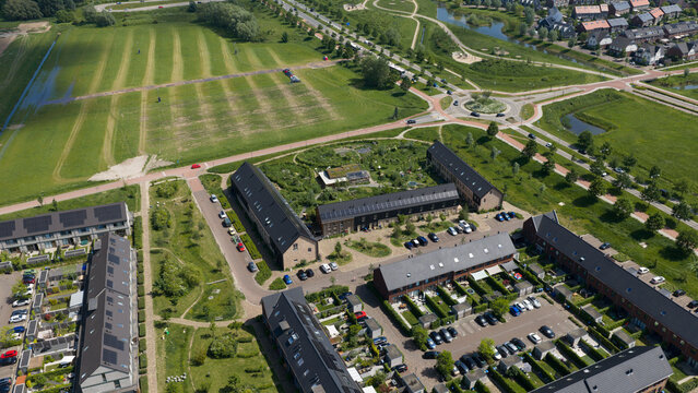 Aerial view of Ecodorp Zuiderveld sustainable housing project featuring green roofs, solar panels, and community gardens in Nijmegen, Gelderland, Netherlands.