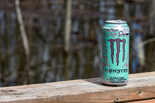Quebec, Canada, 24 April 2026 : A Monster Energy Ultra Vice Guava zero sugar drink can stands on a wooden railing.
