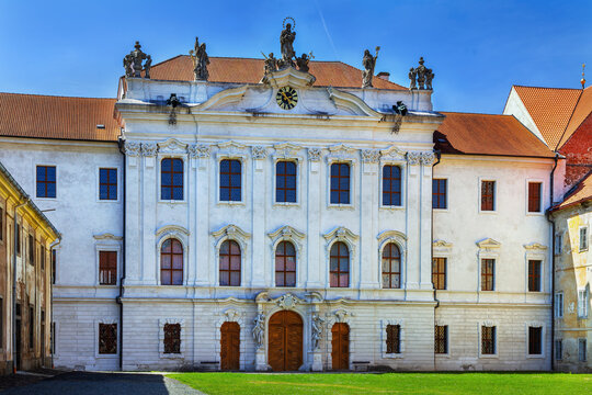 Front view of the white Baroque monastery building at Kladruby Abbey, Czech Republic. Historic palace architecture at day