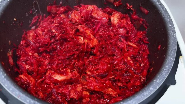 Pork with vegetables during stewing in multicooker for borscht cooking