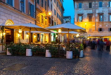 Night cozy old street with tables of restaurant in Trastevere in Rome, Italy. Trastevere is rione of Rome, on west bank of Tiber in Rome. Architecture and landmark of Rome © Ekaterina Belova