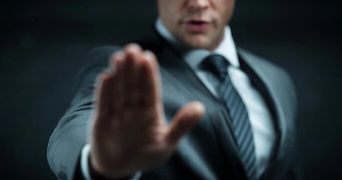 Businessman in suit pointing gesture close up serious portrait leadership executive corporate stop raised hand refusal warning boundary privacy protection security concept with copy space