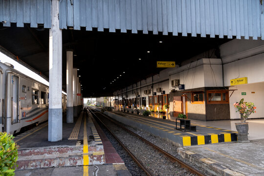 Cilacap, Indonesia - May 14, 2026: A KAI passenger train stop at the platform of the historical Cilacap railway station with colonial architecture.