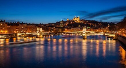 Fototapeta premium Illuminated Historic Bridge Spanning Calm River in European City at Twilight