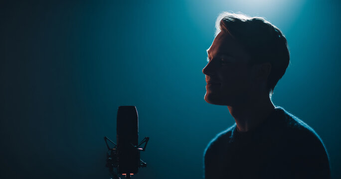 Male singer performing in dark studio
