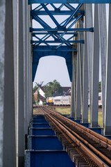 Fototapeta premium A close-up view of the structural steel framework and railway tracks of the historical Renville bridge in Kebumen, Central Java, Indonesia.