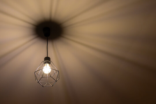 Modern Geometric Pendant Light Casting Shadows on Ceiling
