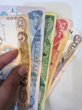 Najaf, Iraq - December 22, 2025: Iraqi Dinar various currency bank note in hand