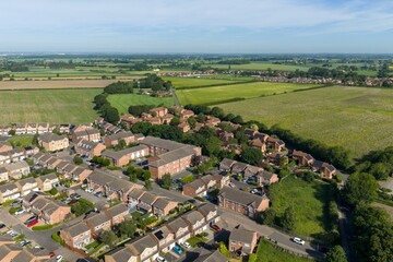 Aerial view of Selby North Yorkshire showing residential housing estates surrounded by farmland countryside and green spaces with extensive rural landscapes stretching across the Vale of York © Duncan