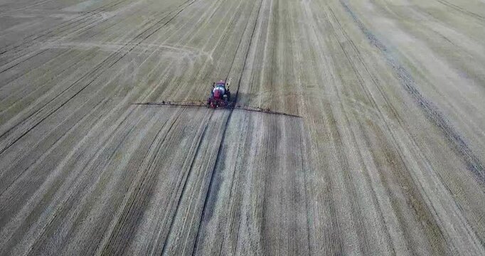 Low altitude drone flight over harvested wheat field