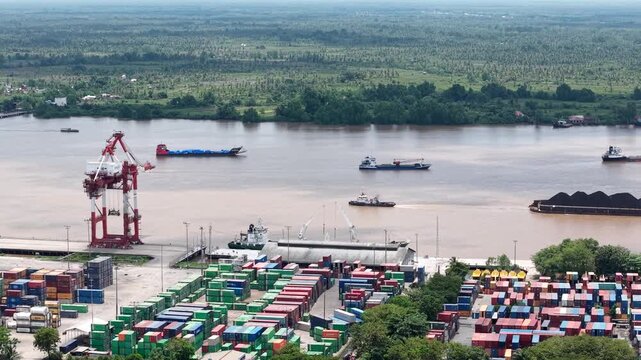 Aerial view of tugboats pulling coal-laden barges near the port