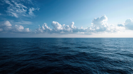 Fototapeta premium Serene Ocean Panorama: Calm Blue Waters Meet Sky's White Clouds, Inspiring Peace