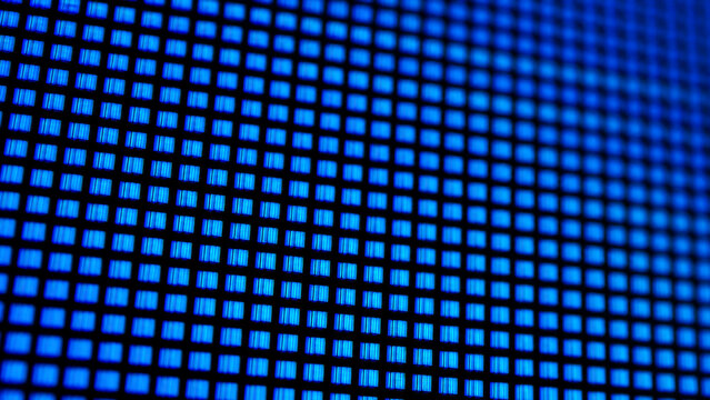 Close-up of a digital display with vibrant blue pixels, showcasing the details of an LED screen for modern tech applications.