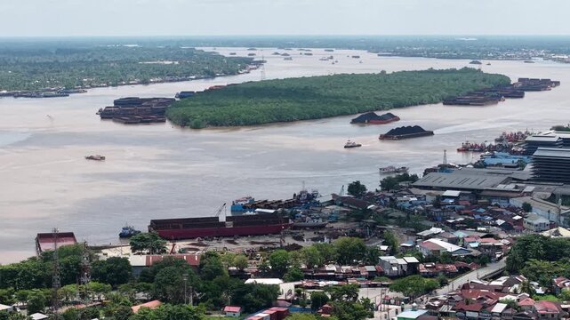 Aerial view of tugboats pulling coal-laden barges near the port