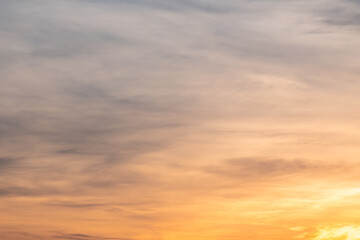 Fototapeta premium Sky sunset,Beautiful sunrise sky with vibrant gradient orange and gold colors and soft blue, Clear atmosphere with wispy clouds. Peaceful, perfect for background and copy space, High resolution images
