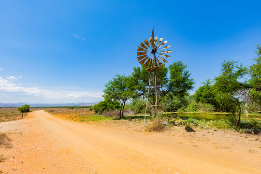 Windmill wind pump borehole in arid landscape