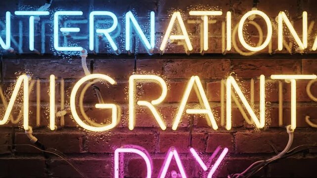 Neon sign displaying international migrants day message on dark brick wall