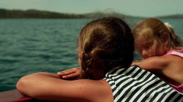 Little girls swimming on a yacht