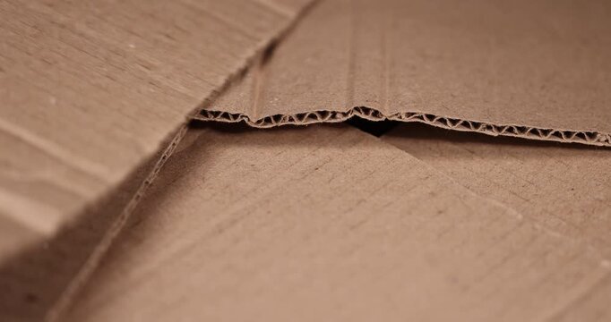 old crumpled cardboard folded for storage, used old cardboard from recycled paper is stored after using it as packaging material, cardboard box