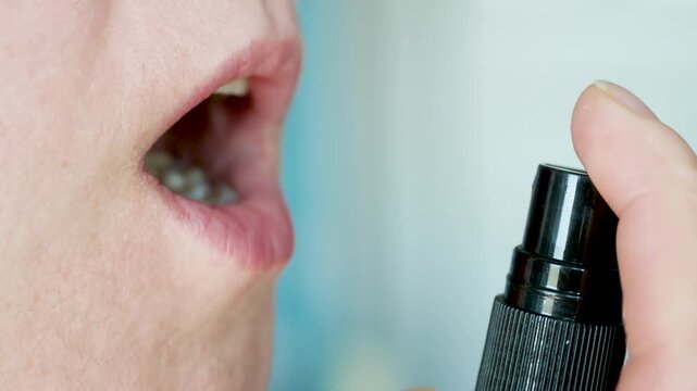 Woman using oral spray for healthcare and wellness routine