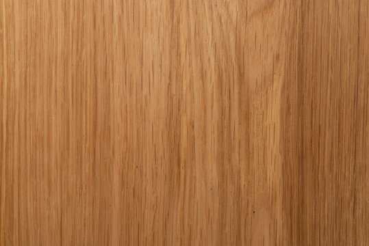 Natural oak wood texture background, light brown wooden board surface with organic grain pattern.