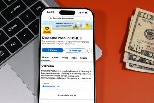 Kiel, Germany - 05-20-2026: Deutsche Post und DHL German postal and logistics services company Profile on LinkedIn displayed in a workspace enviroment with laptop