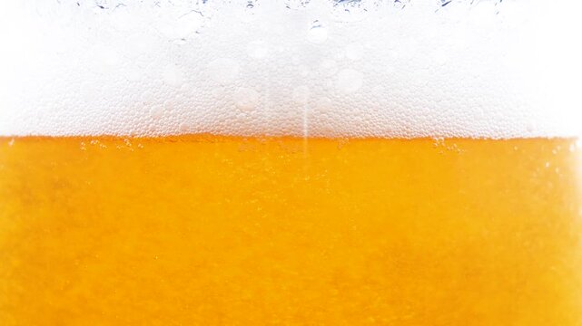  Beer in a glass. The drink is poured into the glass.