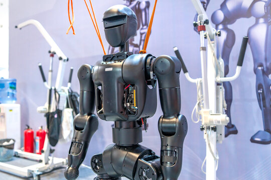 Humanoid Robot with Orange Cables in Tech Exhibition
